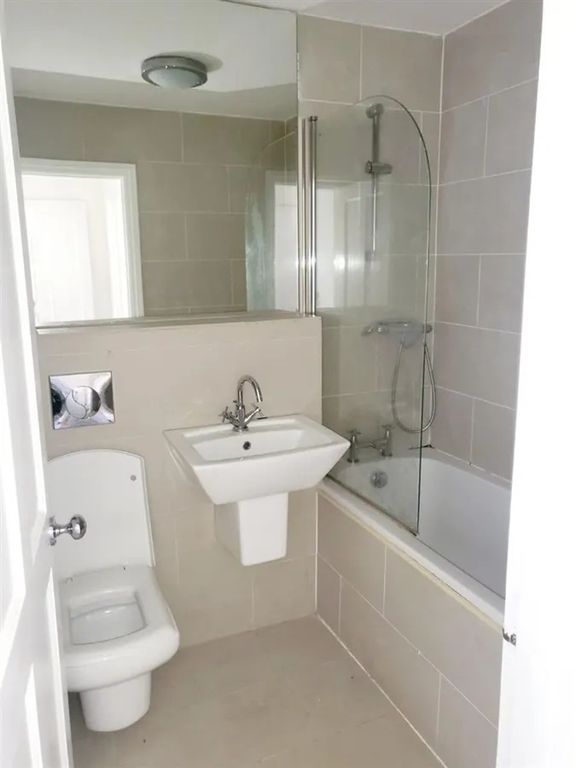 Property photo 3 of 10 Bright And Modern Bathroom Featuring A Clean White...