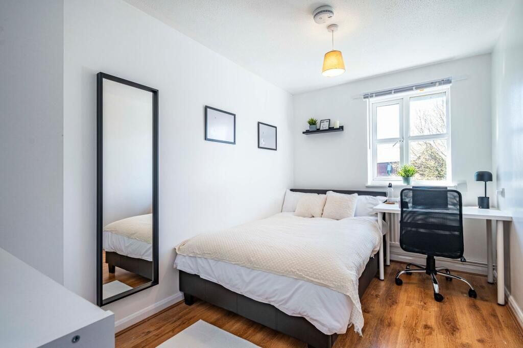 Property photo 3 of 12 A Bright And Inviting Bedroom Featuring A Comforta...