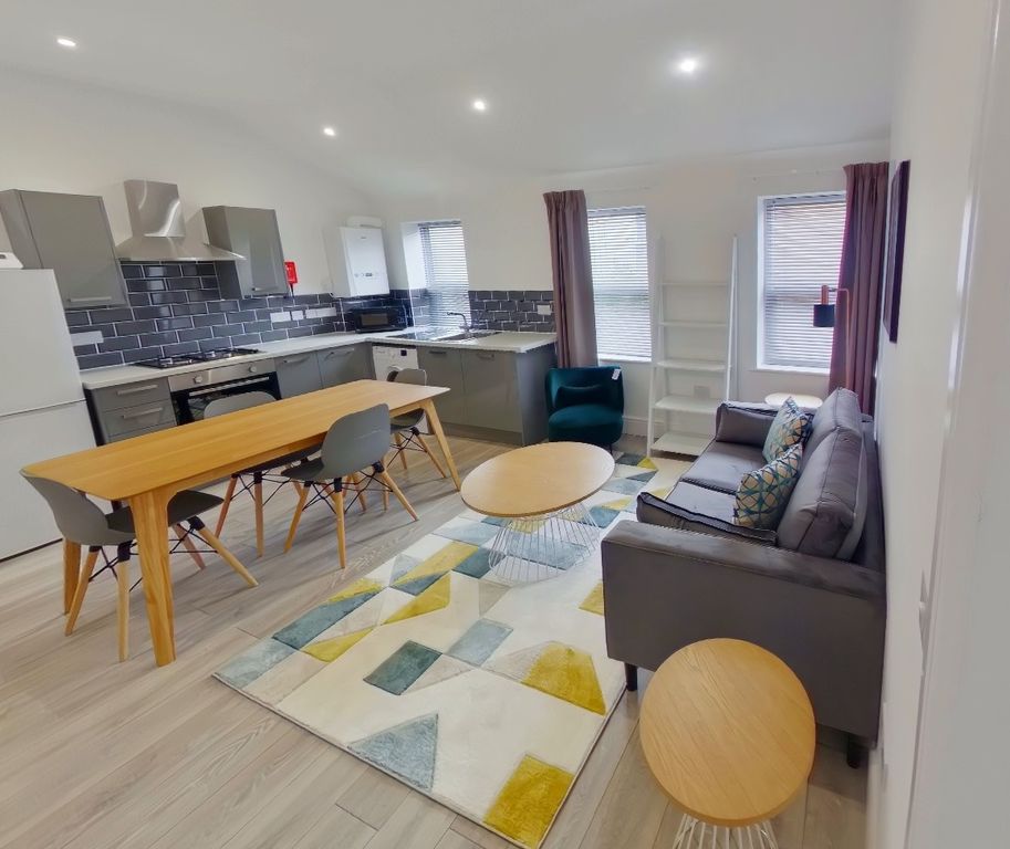 Property photo 2 of 6 A Bright And Spacious Living Room Featuring Modern...