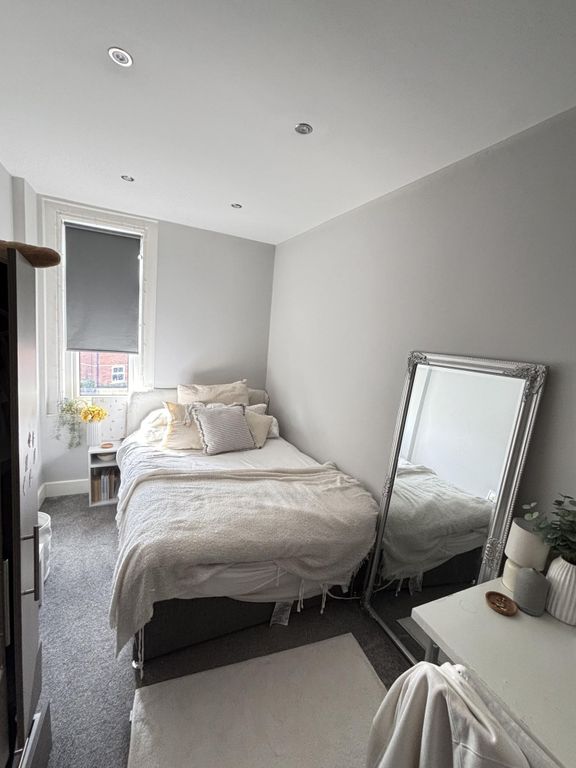 Property photo 2 of 23 A Bright And Cozy Bedroom Featuring A Comfortable ...