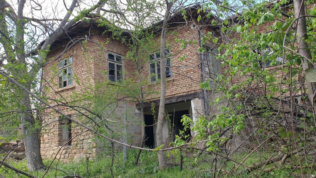 Property photo 1 of 40 Two-Storey Rural House Made Of Brick And Stone With Multiple Windows, Partially Obscured By Trees
