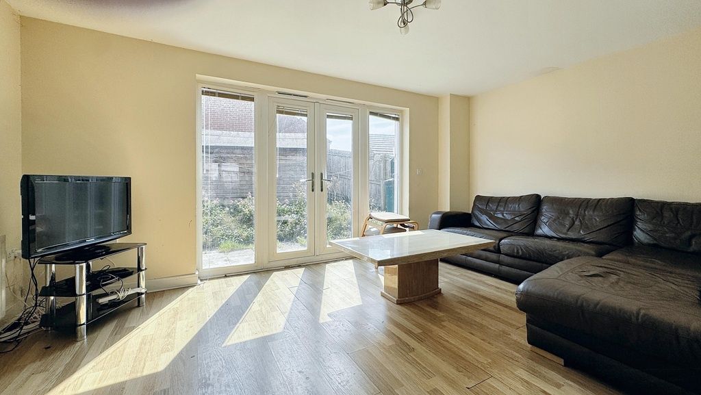 Property photo 3 of 8 A Bright And Spacious Living Room Featuring A Larg...