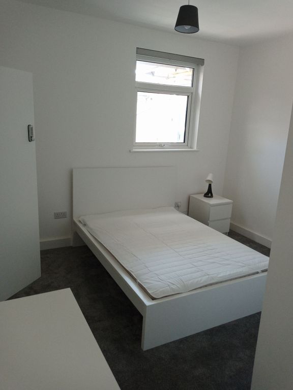 Property photo 1 of 9 Sleek Modern Bedroom With Plush Grey Carpet...