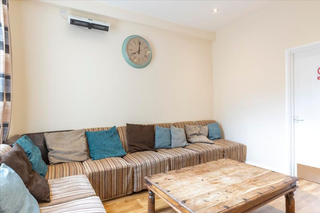 Property photo 2 of 13 This Cozy Living Room Features A Stylish Striped S...