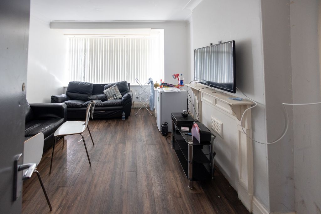Property photo 3 of 7 A Cozy Living Room Featuring Two Black Leather Sof...