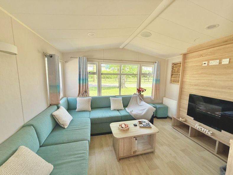 Property photo 1 of 5 Bright Lounge With Aqua L Shaped Seating And Tv Unit