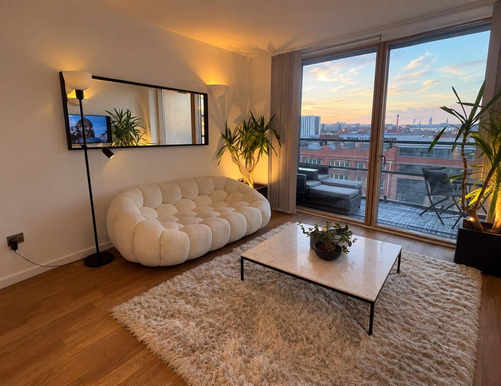 Property photo 1 of 9 Chic Living Room With Balcony And City Sunset View...