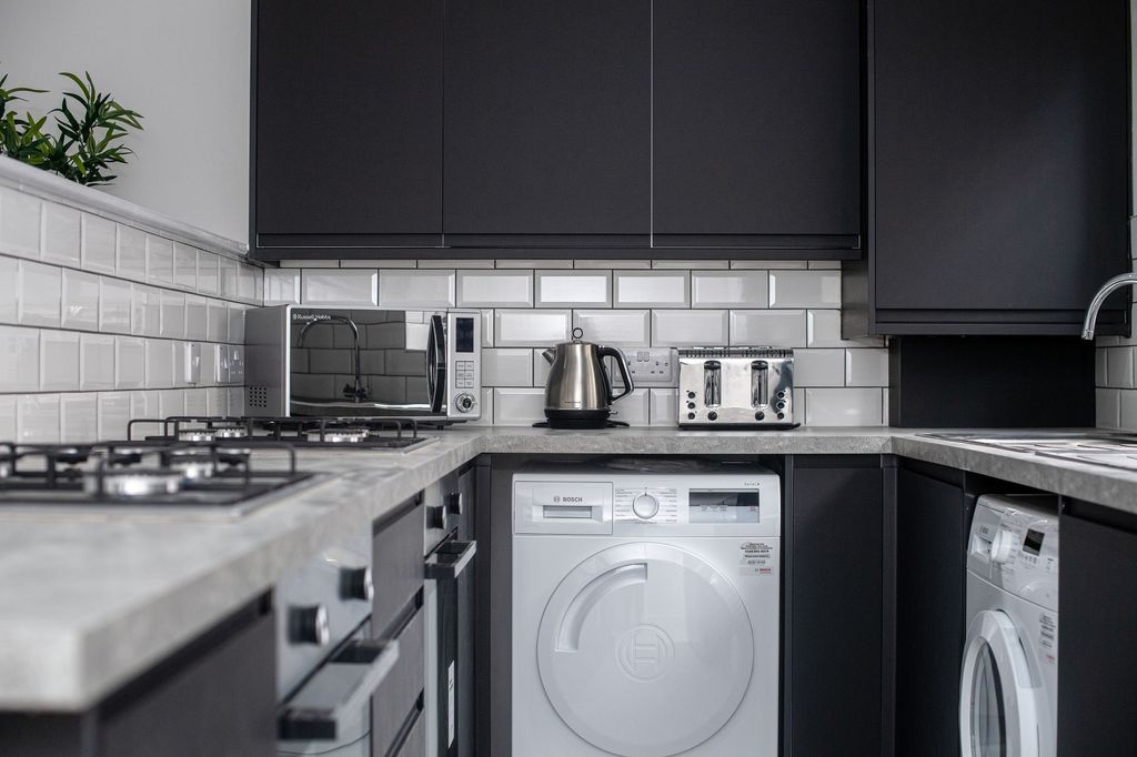 Property photo 2 of 9 Modern Kitchen Featuring Sleek Black Cabinets And ...