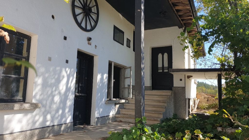 Property photo 1 of 43 White Exterior Wall Of The House Featuring Black Doors, Windows, And A Decorative Wooden Wagon Wheel