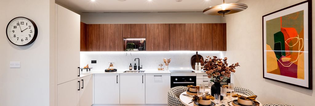 Property photo 1 of 3 Decorated Dining Table, Clock And Wall Hanging, Kitchenette With Wood-Finish Cupboards, White