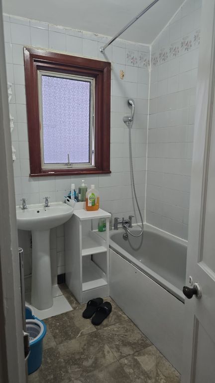 Property photo 3 of 4 Bright Bathroom With Bathtub And Storage Space...