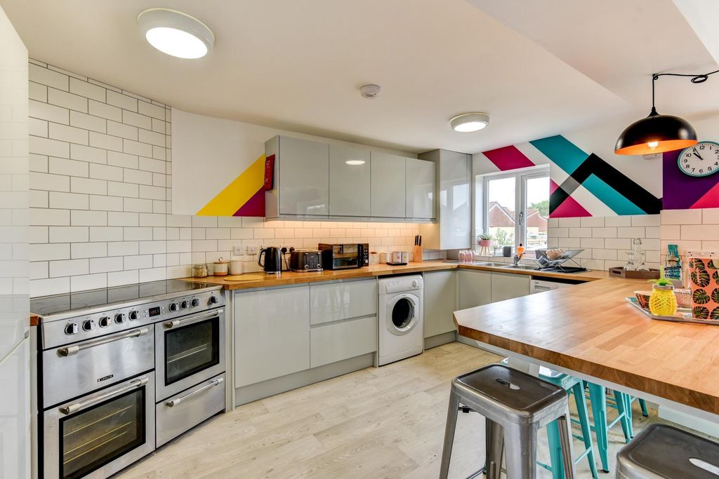 Property photo 2 of 5 This Modern Kitchen Features Sleek Cabinetry And v...