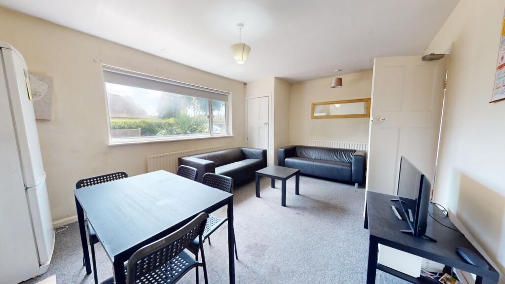 Property photo 2 of 8 A Bright And Inviting Living Room Featuring A Larg...