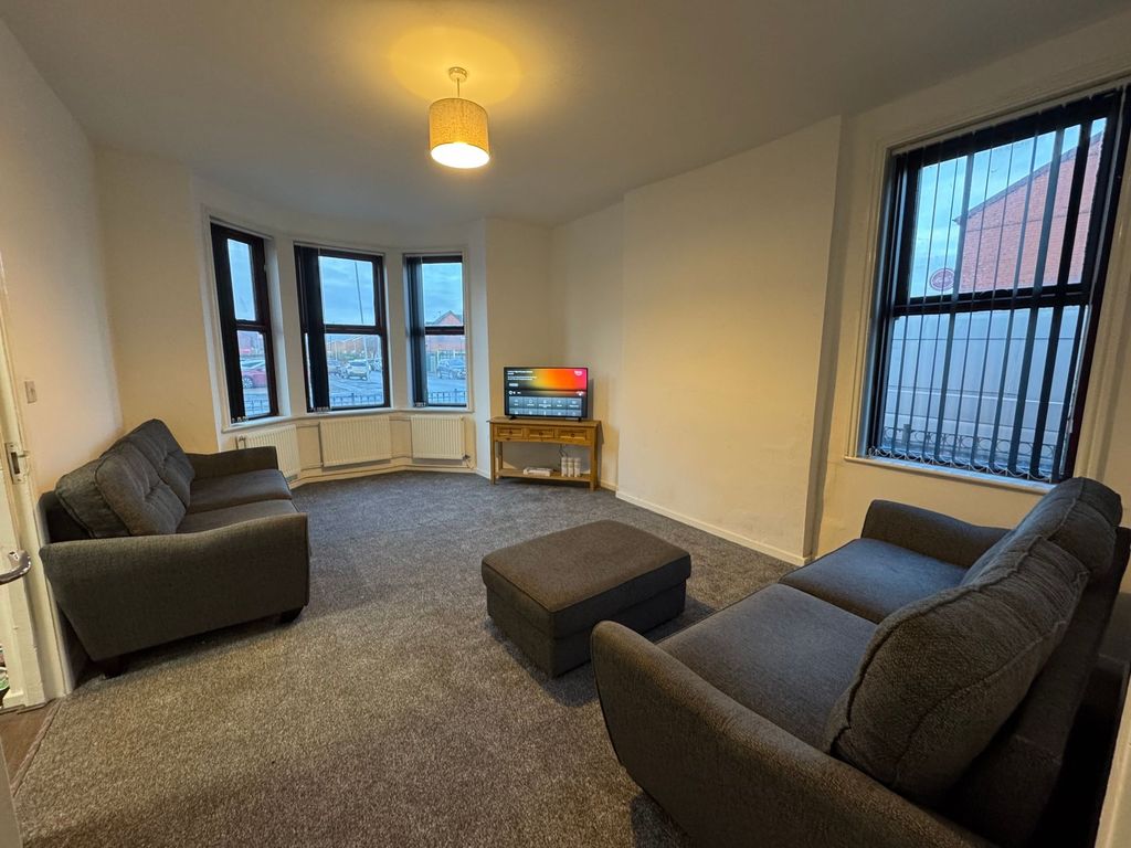 Property photo 3 of 11 A Spacious And Tidy Living Room Featuring Two Comf...