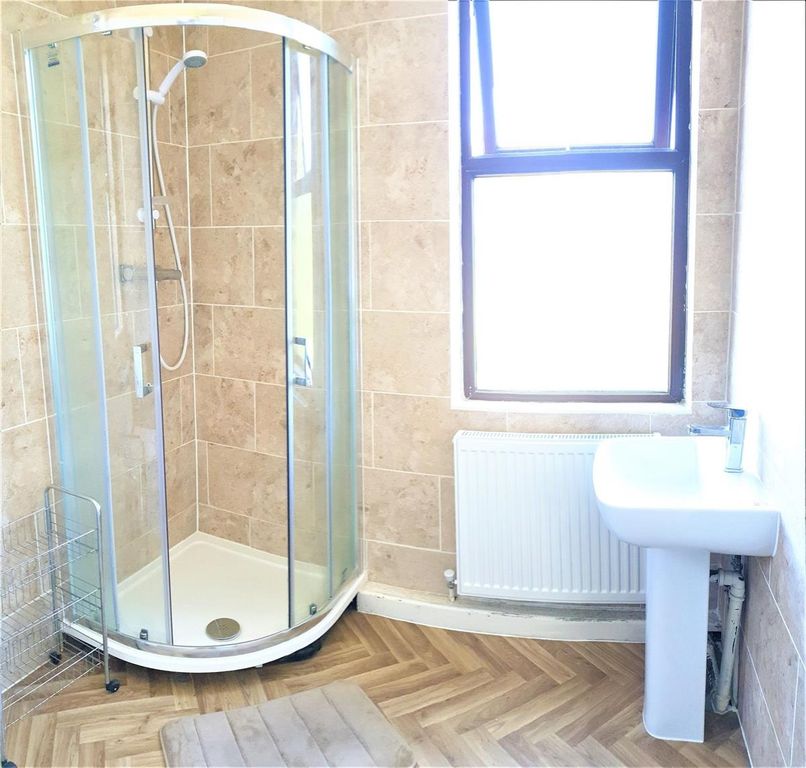 Property photo 3 of 13 A Clean And Well-Lit Bathroom Featuring A Spacious...