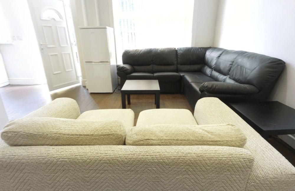 Property photo 1 of 14 Bright, Well-Lit Living Room Featuring Two Sofas A...
