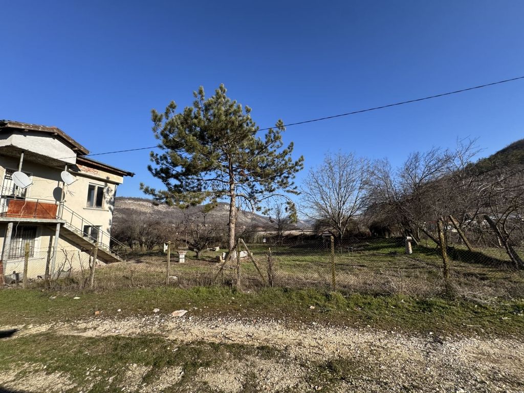 Property photo 3 of 49 View Of A Fenced Grassy Yard Featuring A Pine Tree And A Rural House In The Background Under A Clear Blue Sky.