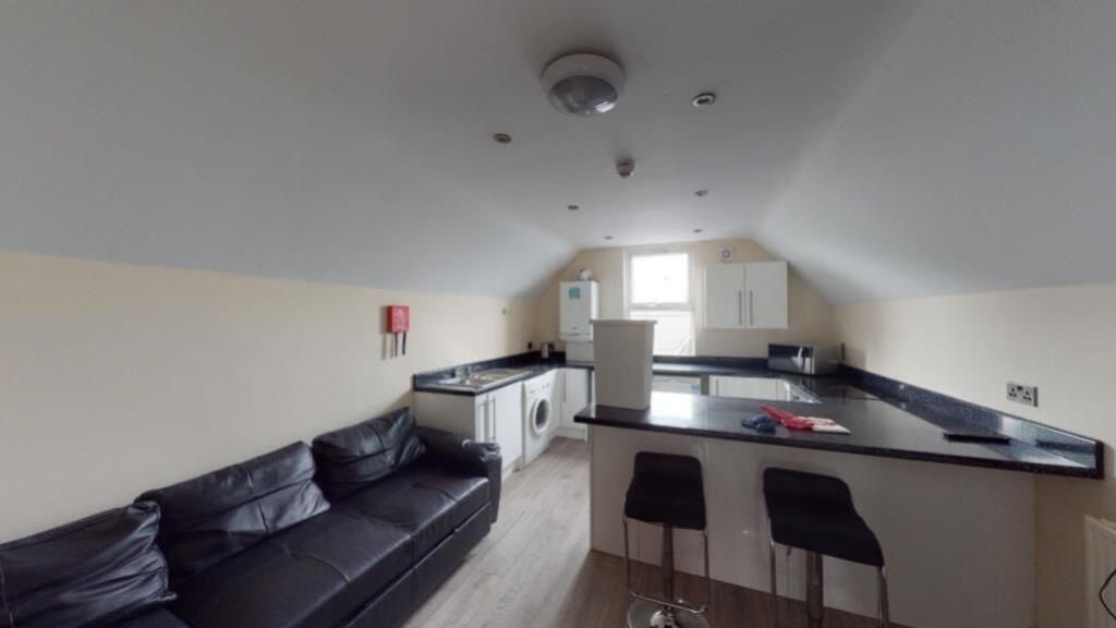 Property photo 2 of 6 Modern Kitchen Area Featuring A Sleek Black Counte...