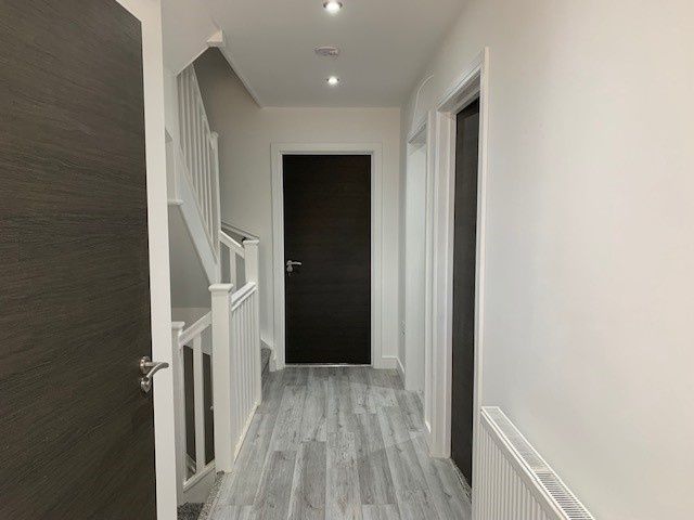 Property photo 2 of 13 A Clean, Modern Hallway With Light Grey Wood Floor...