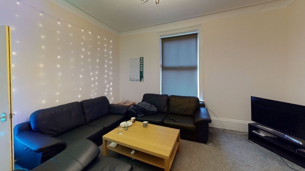 Property photo 1 of 22 A Spacious And Modern Living Room Featuring A Larg...