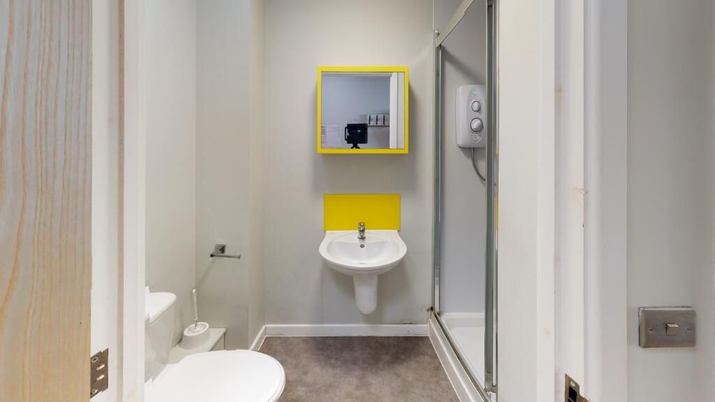 Property photo 3 of 4 A Modern Bathroom Featuring A Clean White Toilet, ...
