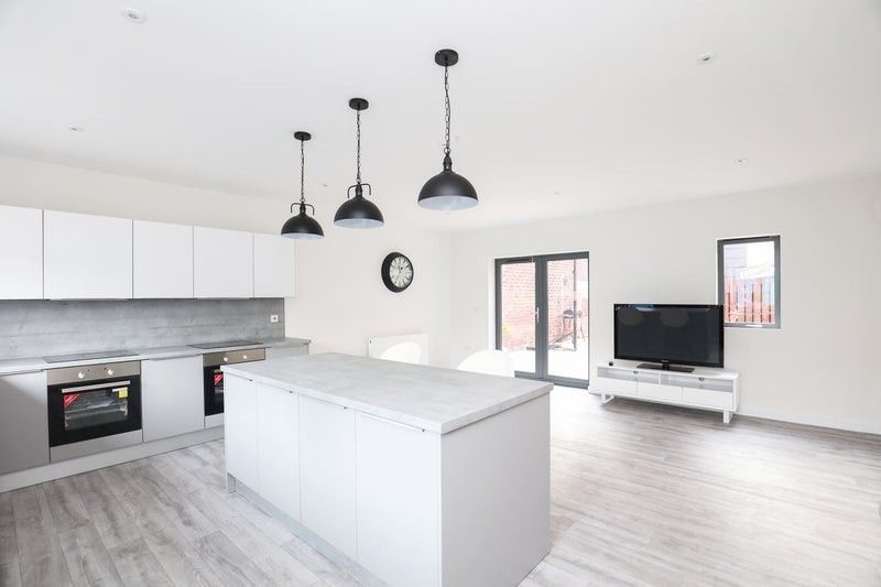 Property photo 2 of 4 Modern, Bright Living Room Featuring Large Windows...