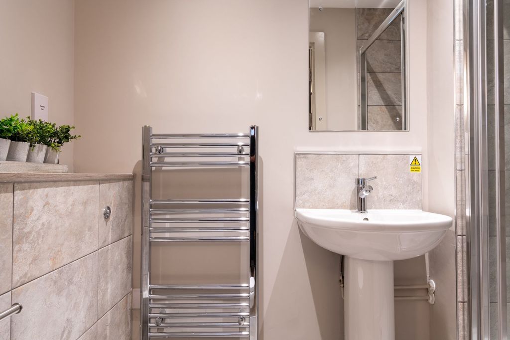 Property photo 3 of 3 Well-Maintained Bathroom With A Modern Pedestal Si...