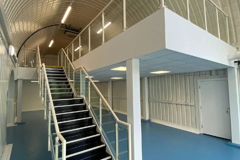 Property photo 2 of 3 An Arch With Lining And A Ground Floor Level And A Mezzanine Level, Connected By Stairs.