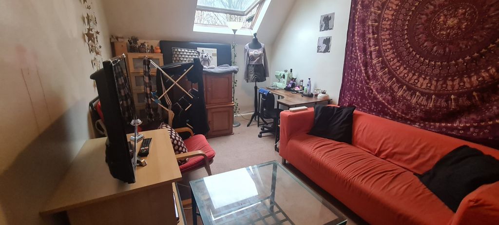 Property photo 2 of 9 A Cozy Living Room Featuring A Comfortable Sofa An...