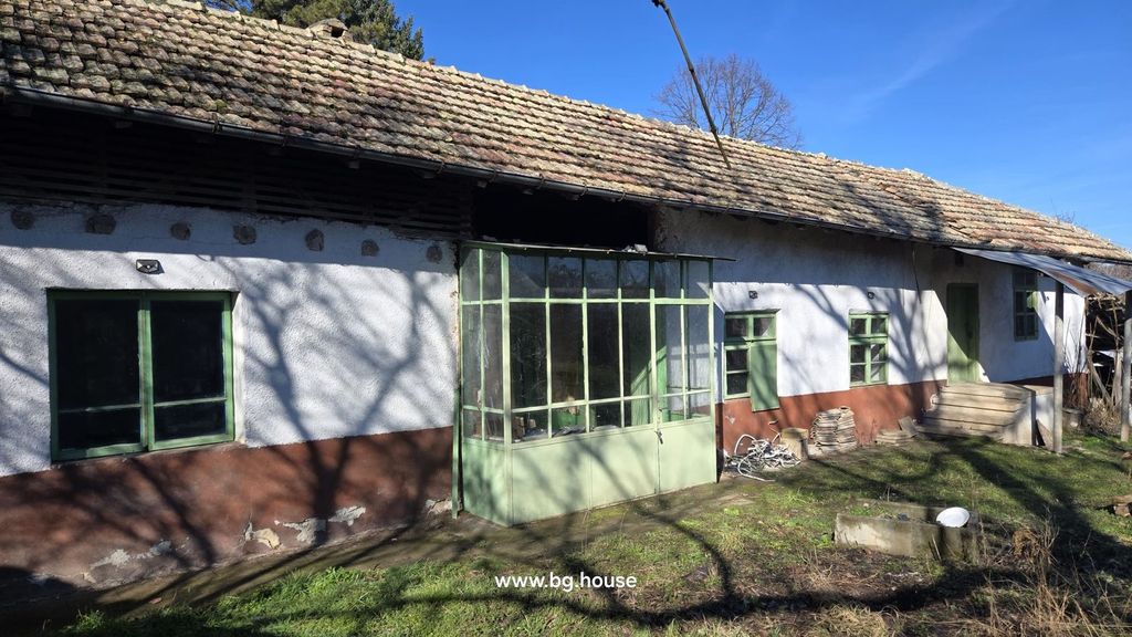 Property photo 1 of 54 Front View Of A Traditional Bulgarian House With White And Brown Walls, Green Framed Windows, And A Tiled Roof.
