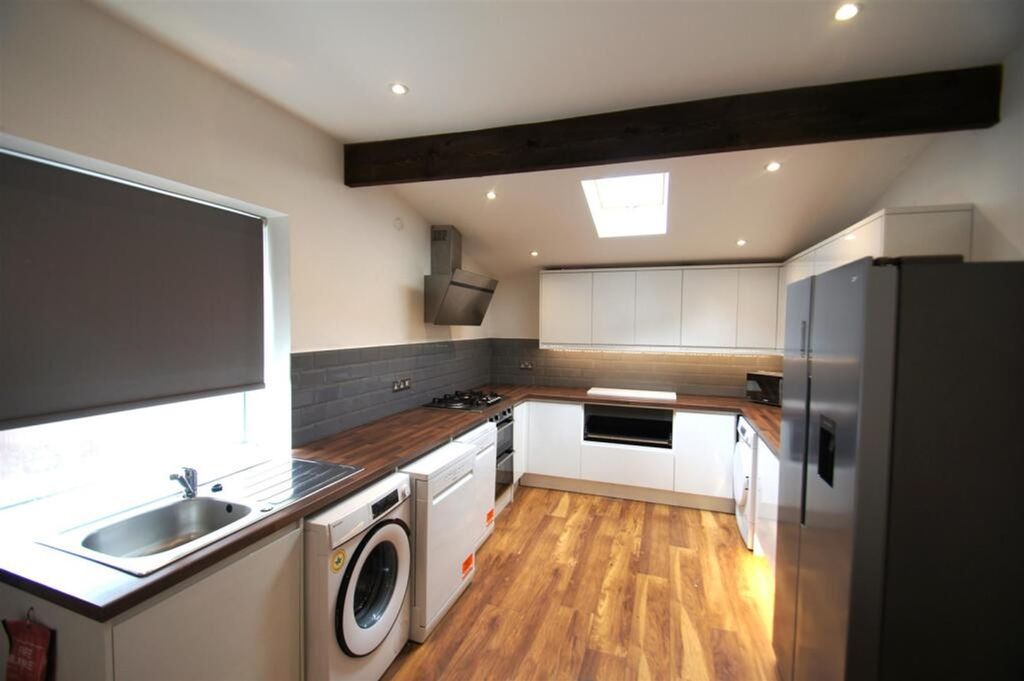 Property photo 3 of 12 Modern Kitchen Featuring Sleek Cabinetry, Ample Co...