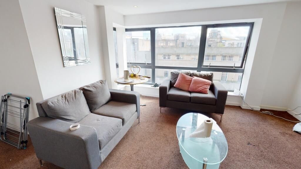 Property photo 3 of 6 A Bright Living Room Featuring Large Windows That ...