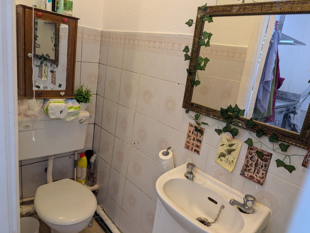 Property photo 1 of 9 Charming Tiled Bathroom With Unique Decor...