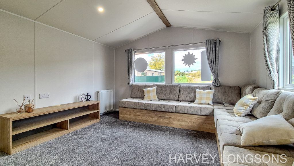 Property photo 3 of 16 Spacious Lounge With L-Shaped Seating And Large Windows.