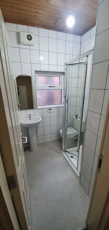 Property photo 3 of 4 Bright, Tiled Bathroom Featuring A Corner Glass Sh...