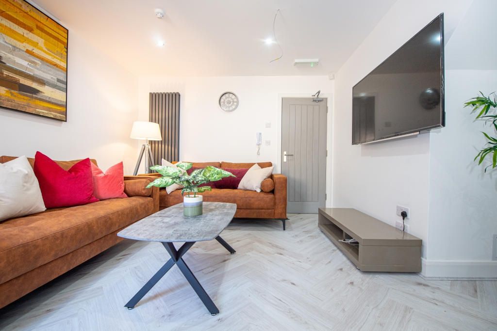 Property photo 1 of 15 A Bright And Inviting Living Room Featuring Modern...