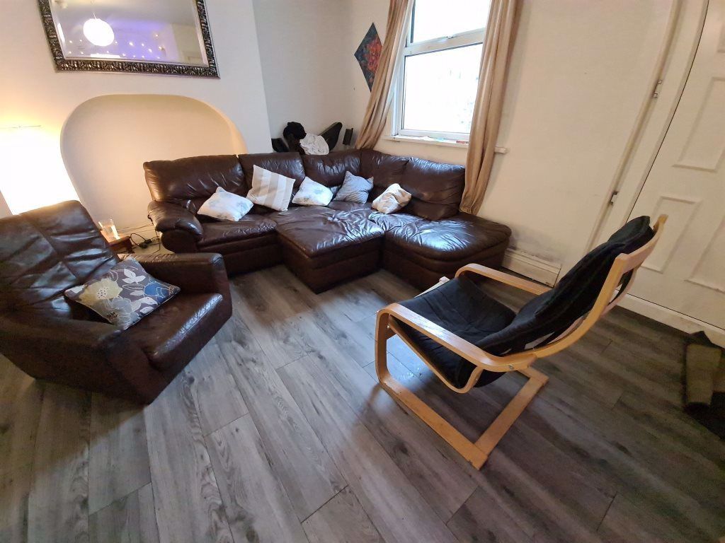 Property photo 2 of 25 A Spacious And Inviting Living Room Featuring Comf...