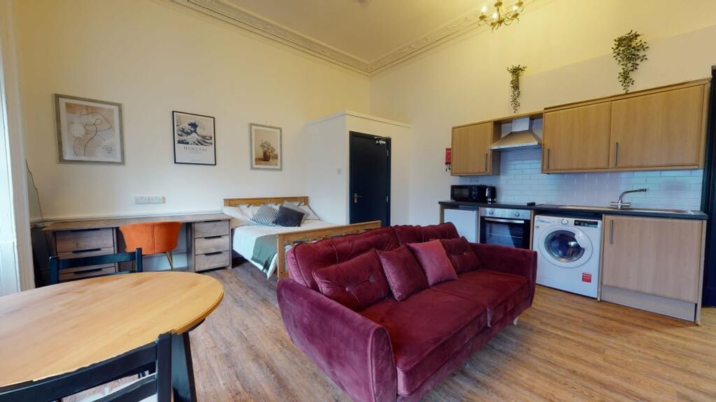 Property photo 2 of 3 A Spacious And Stylish Living Room Featuring Moder...
