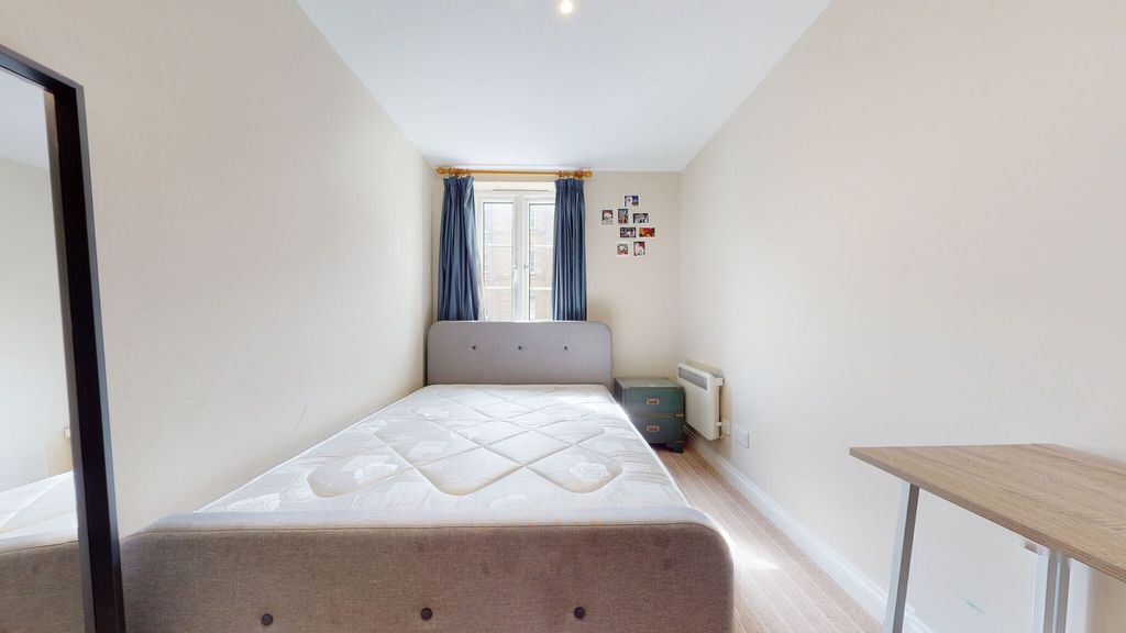 Property photo 3 of 14 Bright And Simple Bedroom Featuring A Comfortable ...