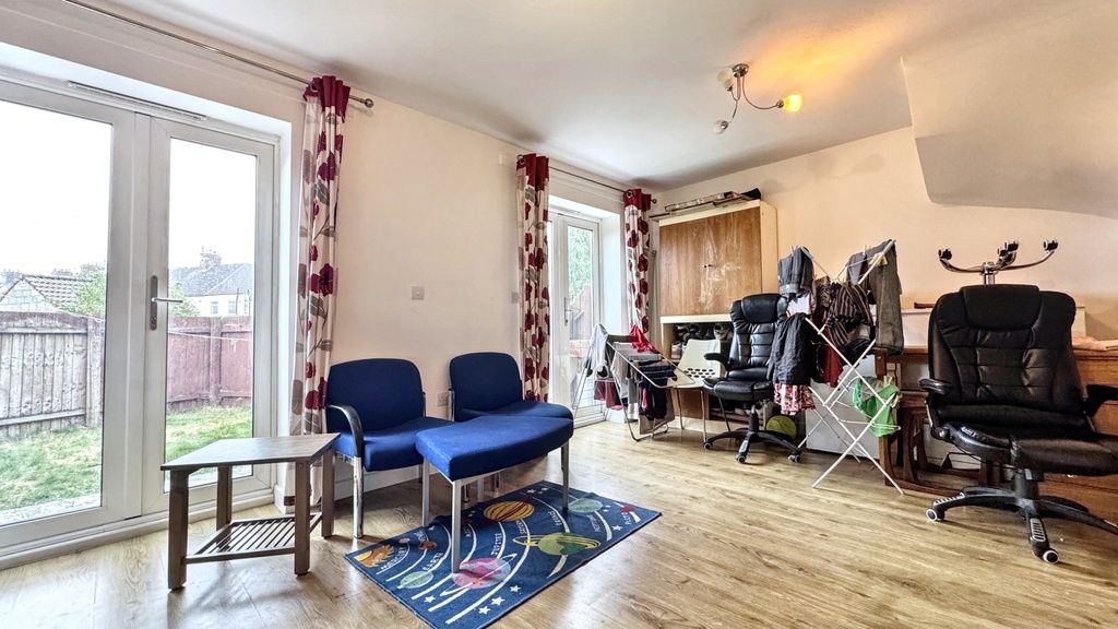 Property photo 1 of 14 A Spacious And Well-Lit Living Room Featuring Comf...