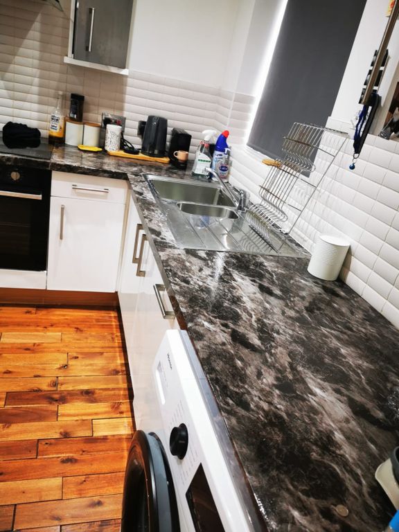 Property photo 1 of 5 Modern Galley Kitchen With Dark Marble-Effect Work...