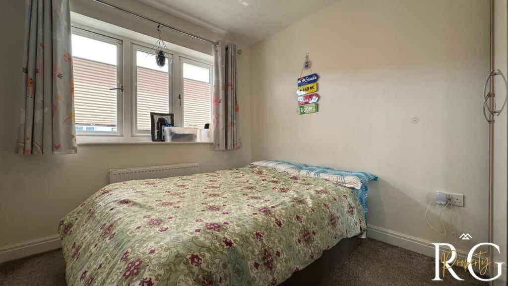 Property photo 3 of 9 A Cozy Bedroom With A Comfortable Bed, A Window Al...