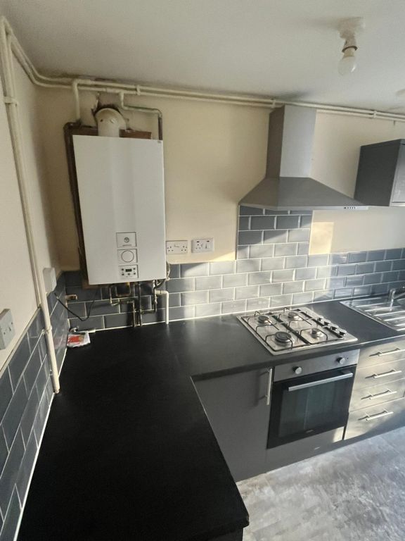 Property photo 1 of 12 A Modern And Tidy Kitchenette Featuring Sleek Blac...
