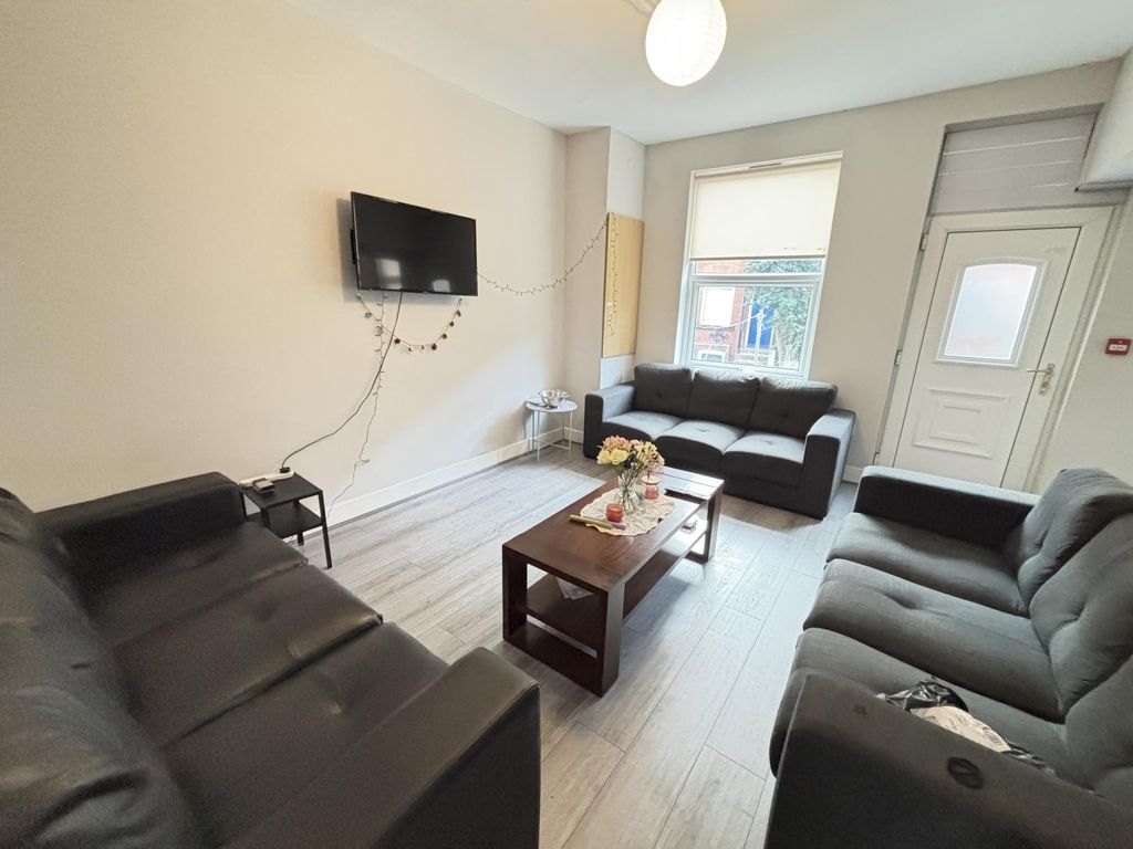 Property photo 1 of 16 A Bright And Inviting Living Room Featuring Comfor...