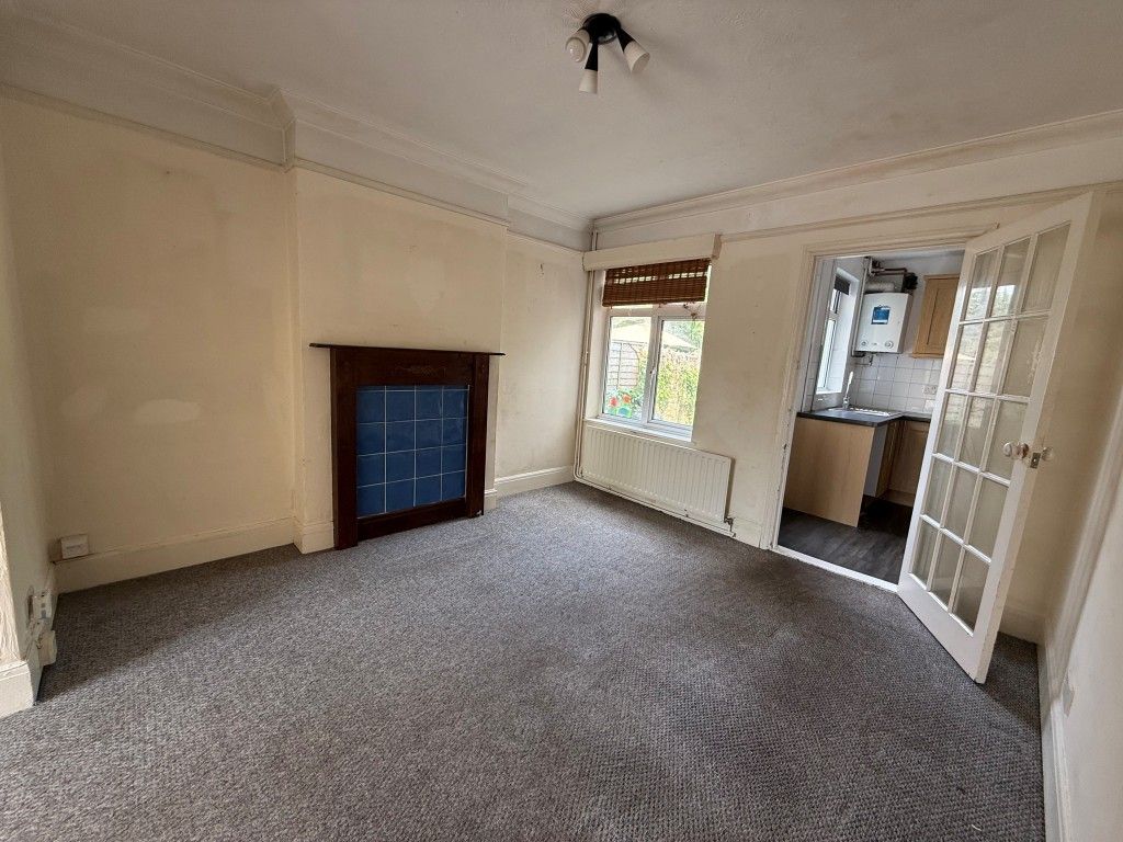 Property photo 3 of 12 Carpeted Dining Room With Window And Doors To Kitchen