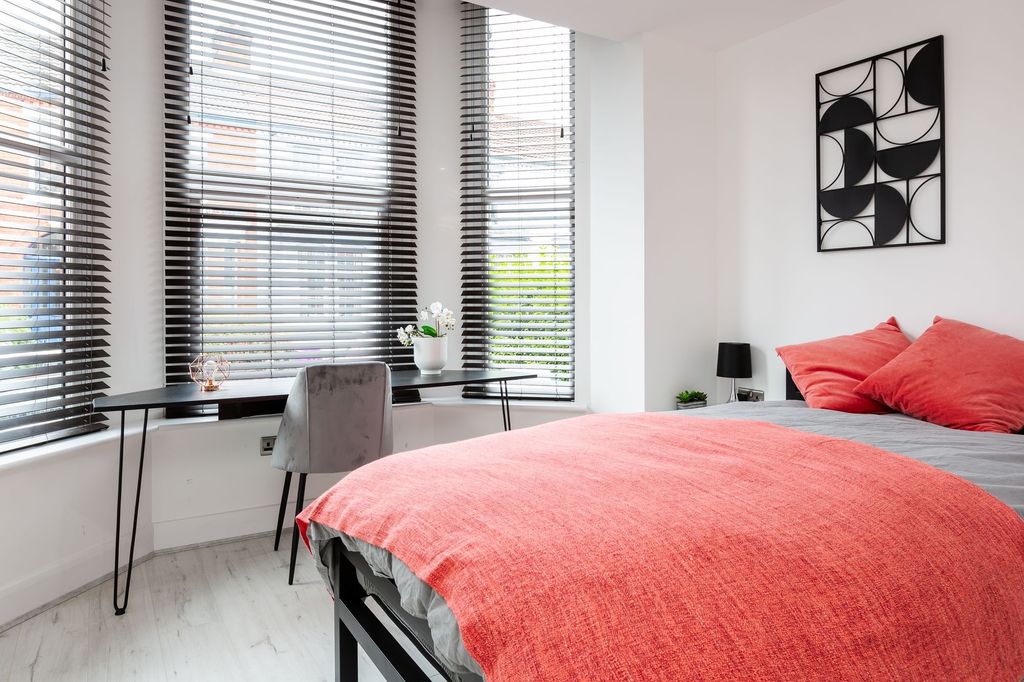 Property photo 3 of 7 A Bright, Modern Bedroom Featuring Large Windows W...