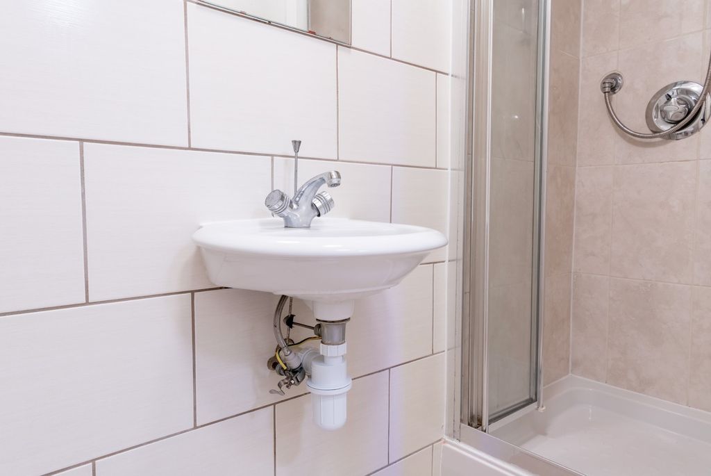 Property photo 2 of 14 A Clean And Modern Bathroom Featuring A Sleek Sink...
