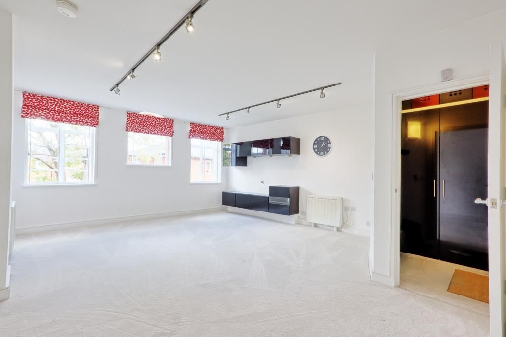 Property photo 2 of 10 Carpeted Living Area With 3 Windows And Media Cabinet