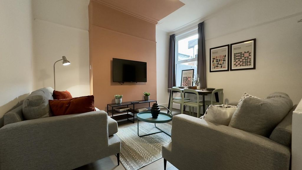 Property photo 1 of 7 A Spacious And Stylish Living Room With Modern Dec...