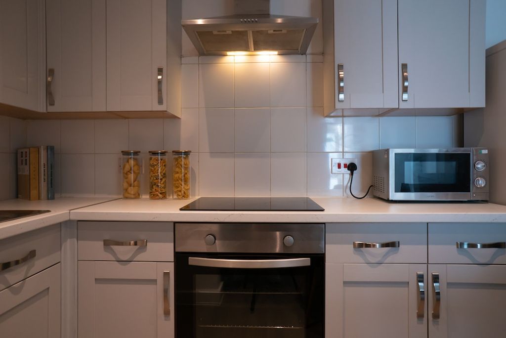Property photo 3 of 4 A Modern And Tidy Kitchen Featuring Sleek Cabinetr...
